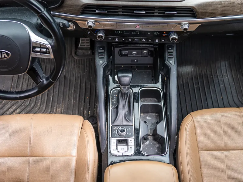 Front console and floor mats before detailing, dusty trim and dirty mats